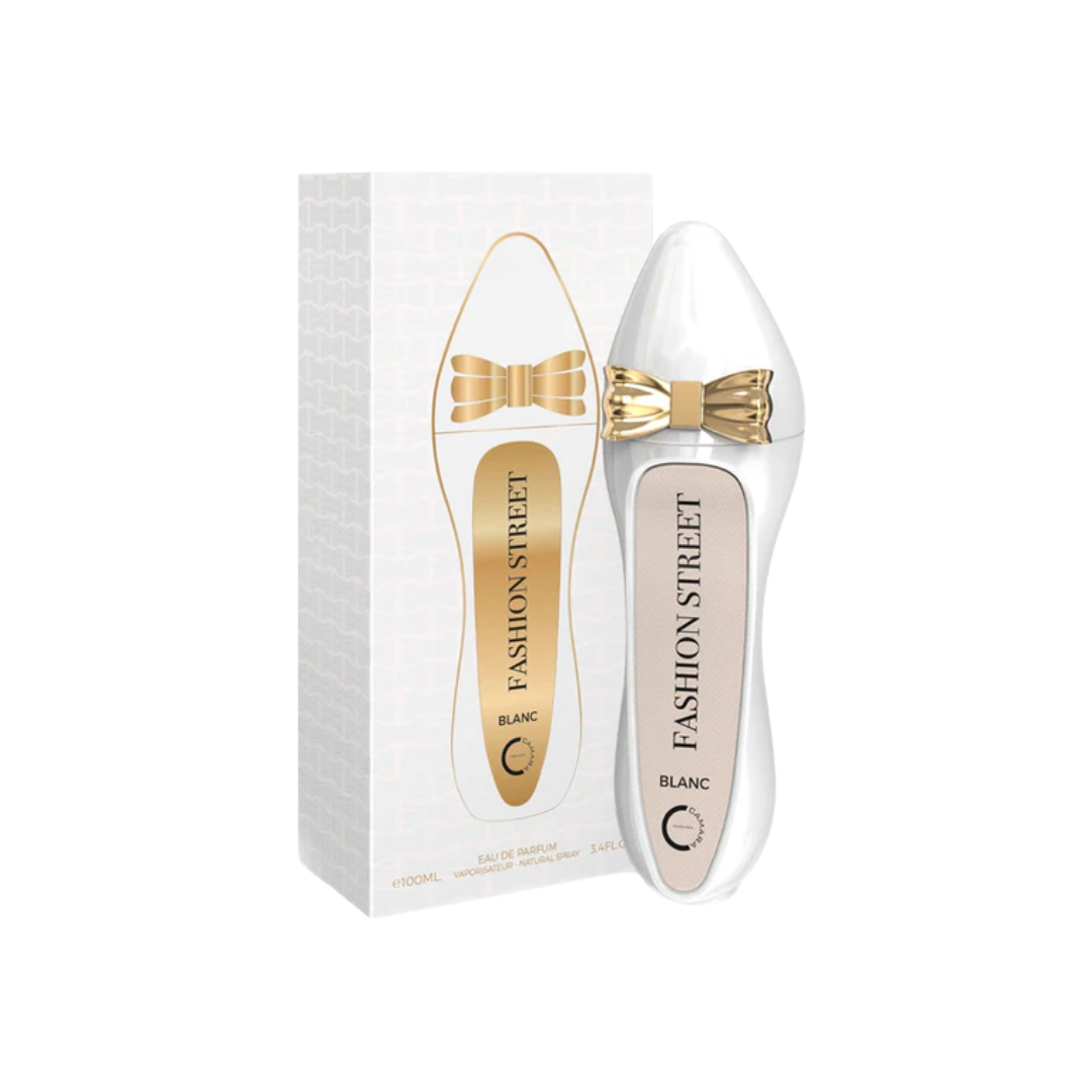 Camara Fashion Street Blanc 100ml with a unique white shoe-shaped bottle design, featuring a golden bow, for a floral fragrance with almond, rose, and vanilla.